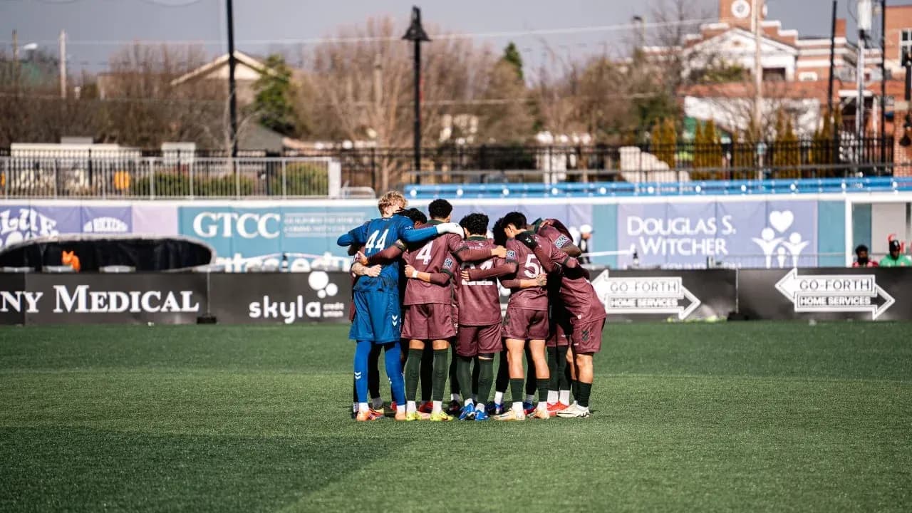 Players huddled together before the match