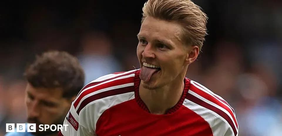 Player celebrating in Arsenal jersey during match
