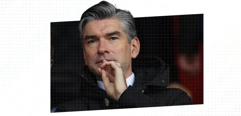 Man in black jacket observing from the stands