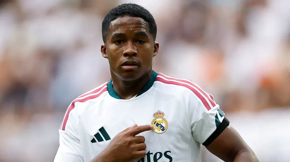 Player pointing to Real Madrid crest on jersey
