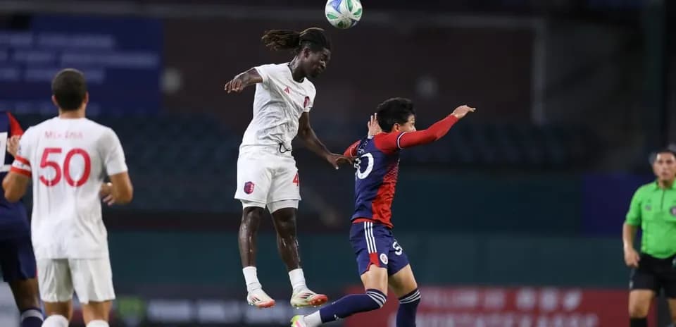 Player jumping to head the ball during match