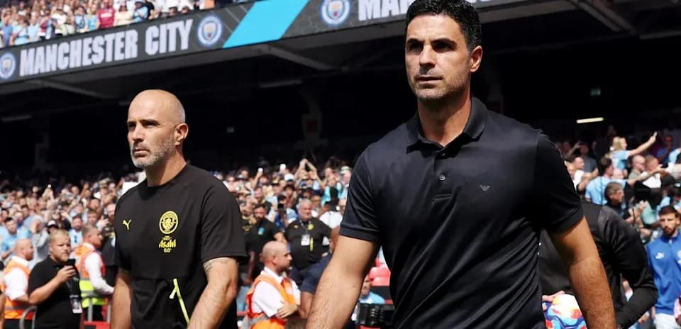 Coaches walking onto the pitch before match