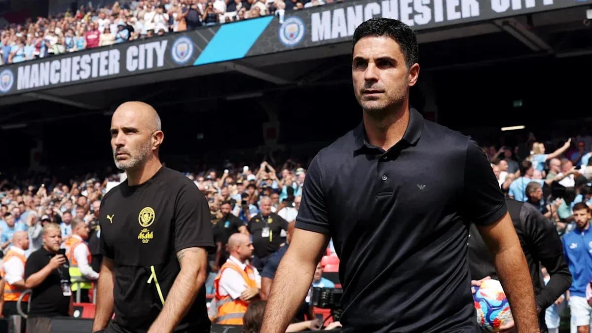 Coaches walking onto the pitch before match