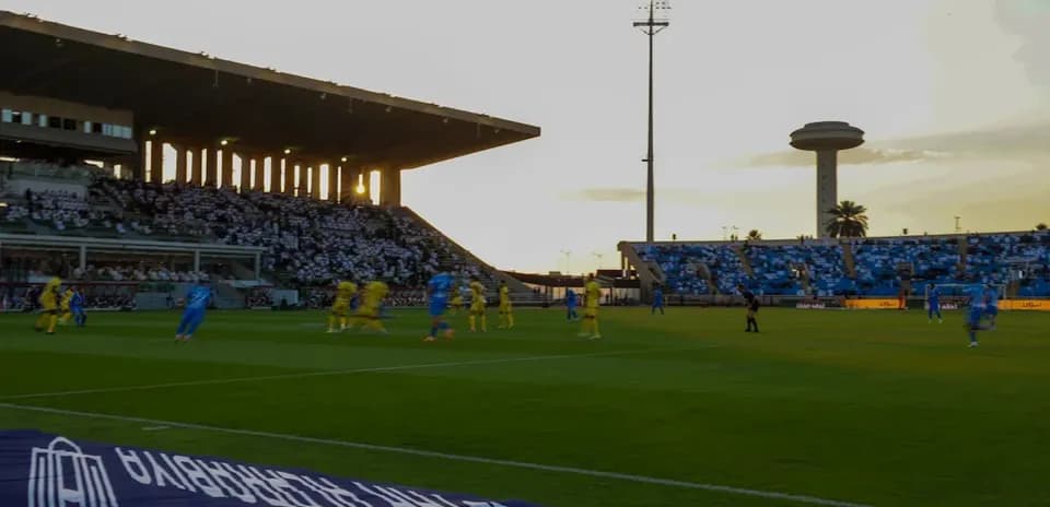 Players in blue and yellow competing on the pitch