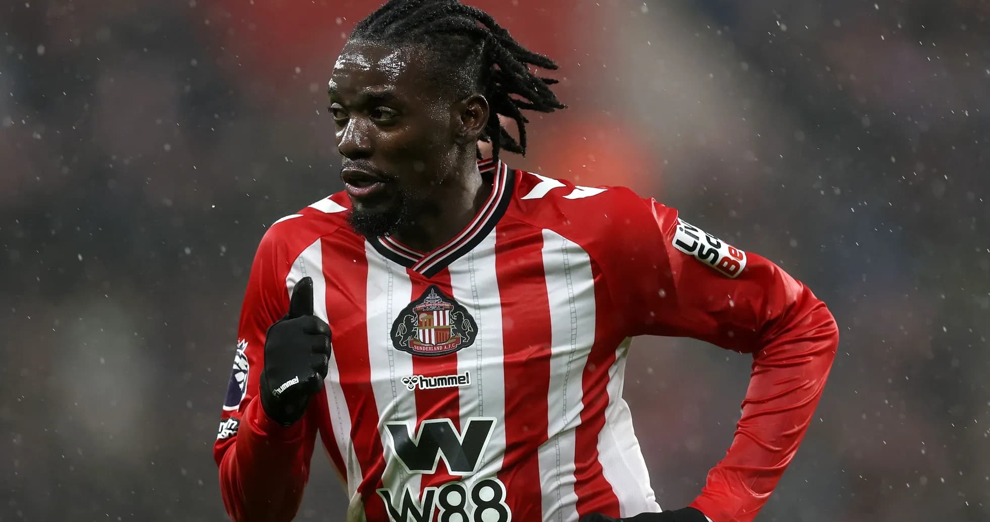 Player running in Sunderland FC home kit during match