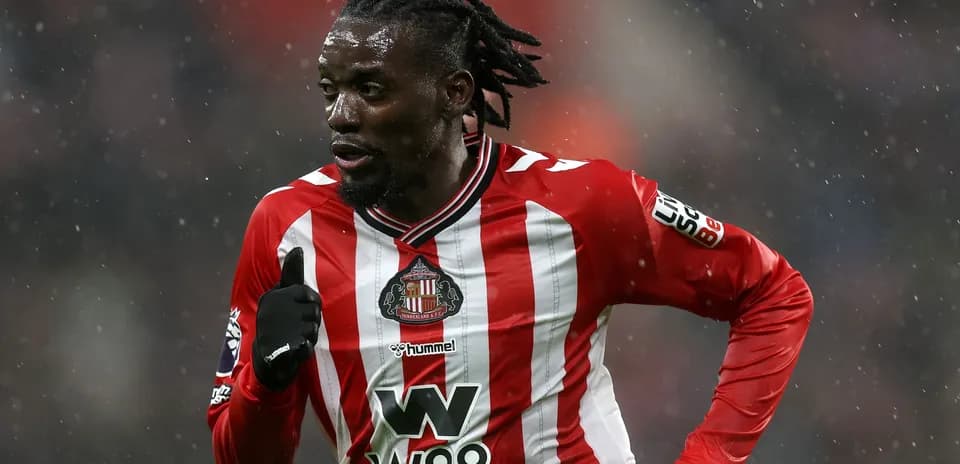 Player running in Sunderland FC home kit during match