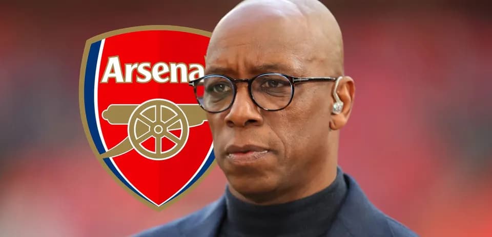 Person in front of Arsenal logo during event