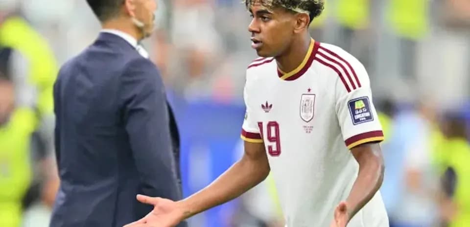 Player gesturing while speaking to coach during match