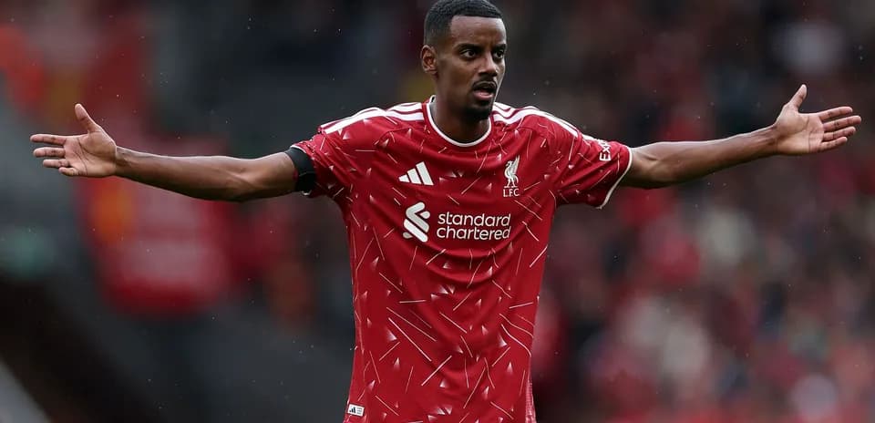 Player gesturing during match in Liverpool jersey