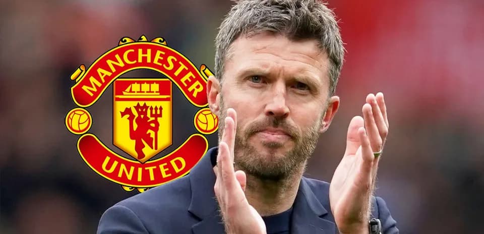 Coach clapping with Manchester United logo in background