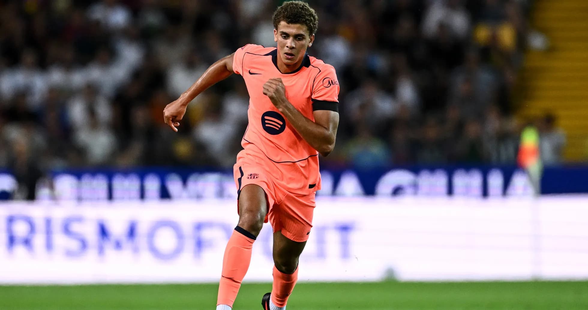 Player running in pink kit during match