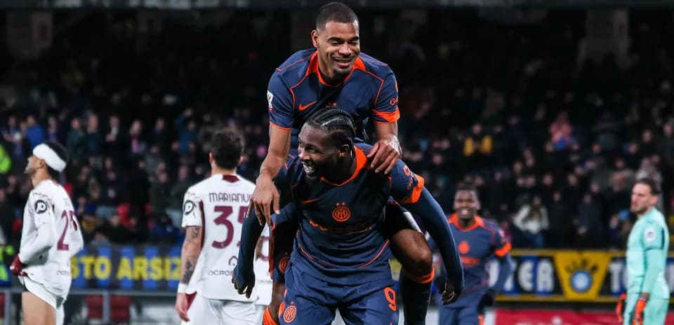 Players celebrating with a piggyback after scoring