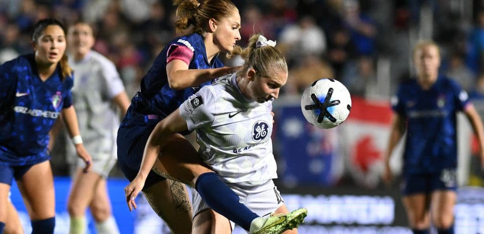 Players competing for the ball during NWSL match