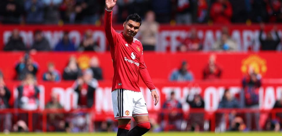 Player waving to fans at Old Trafford stadium