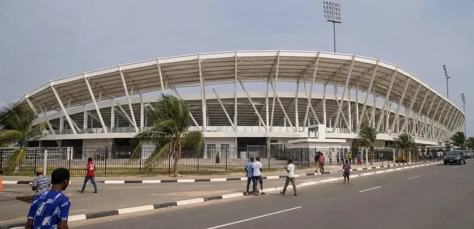 Exterior view of stadium with people walking nearby