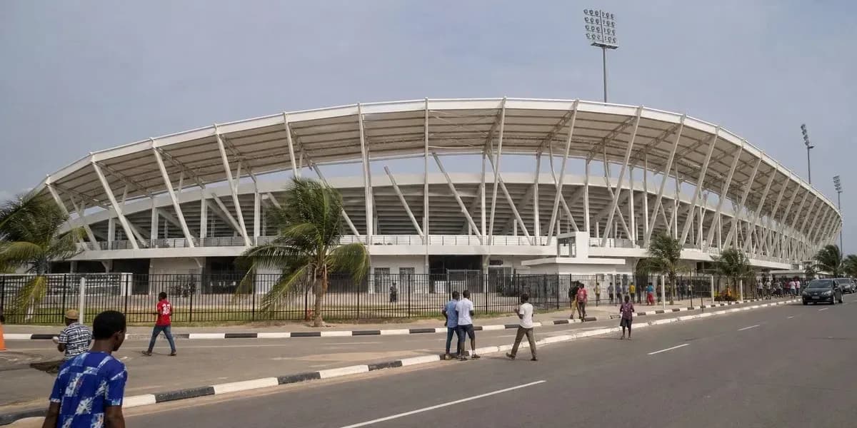 Exterior view of stadium with people walking nearby