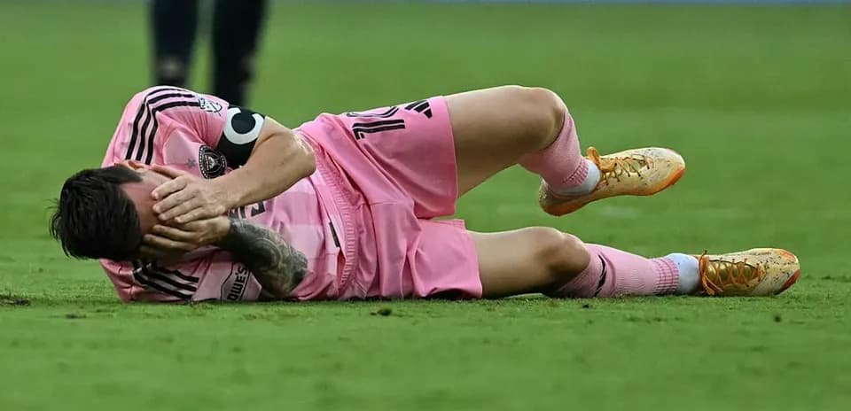 Player lying on the field, holding face in pain