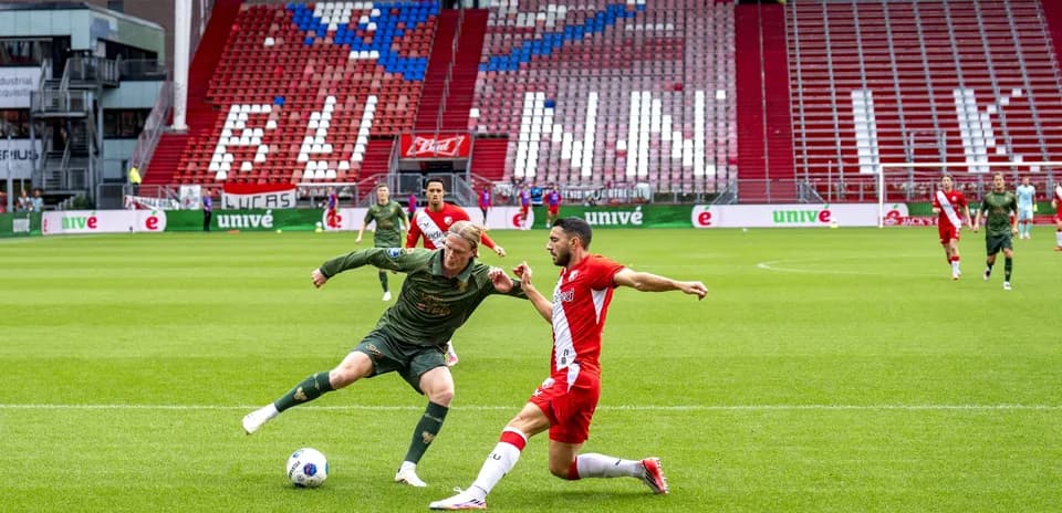 Two players battling for the ball on the pitch