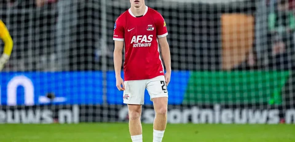 Player in red jersey standing on the pitch