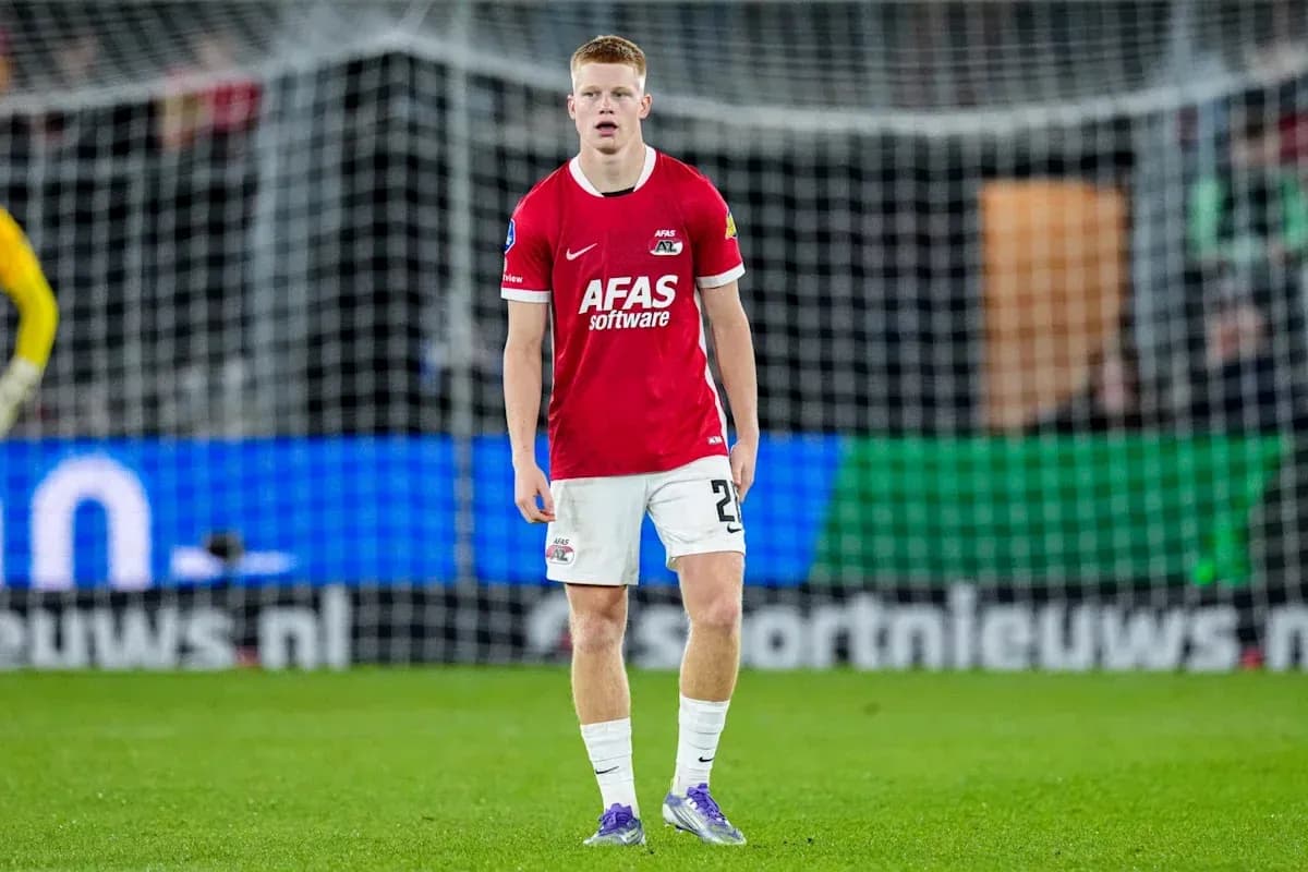Player in red jersey standing on the pitch