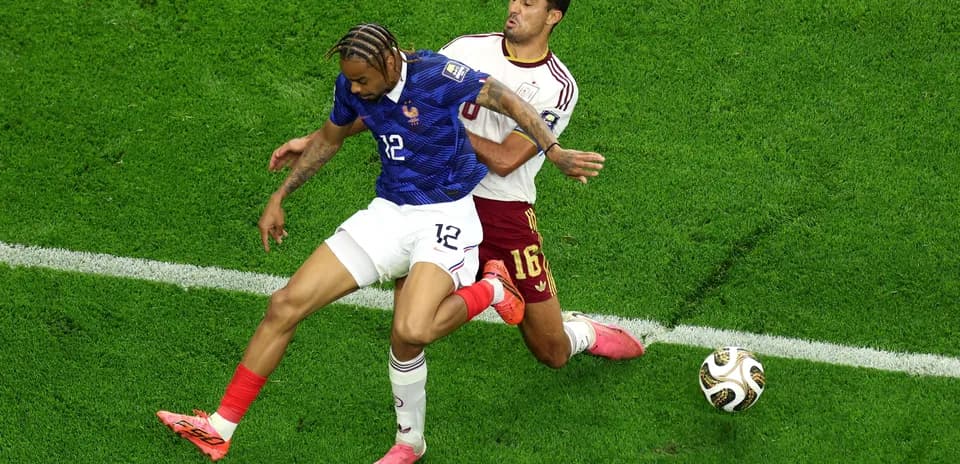 Two players competing for the ball during match