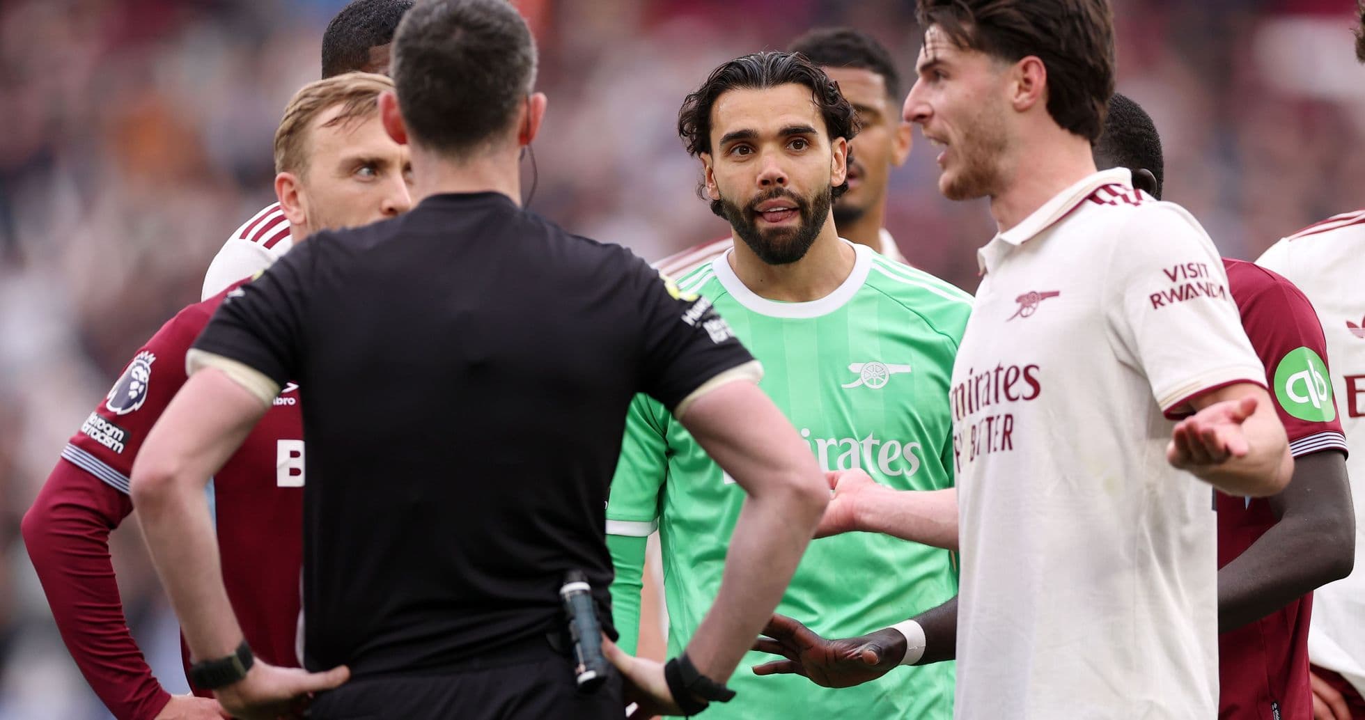 Players discussing with referee during match confrontation