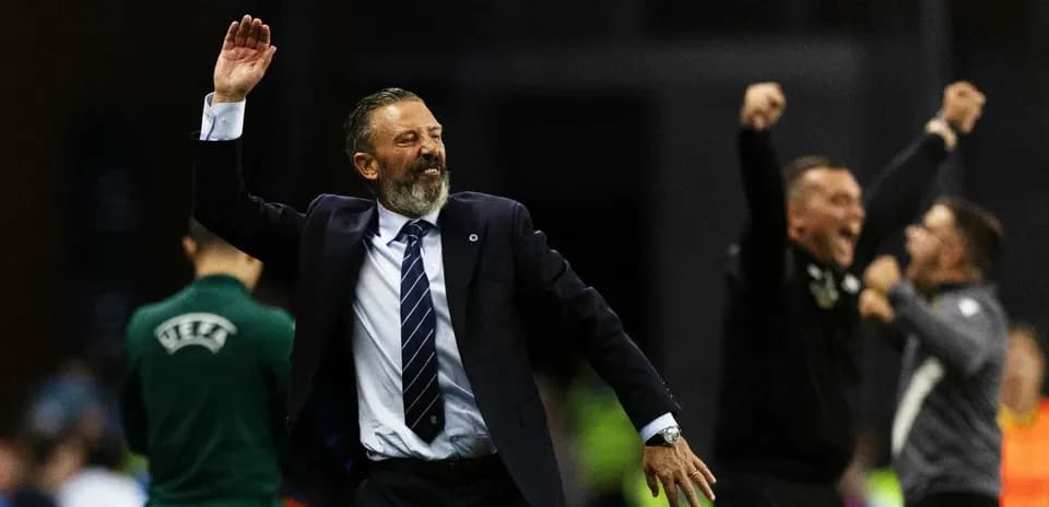 Coach celebrating victory with raised hand and smile