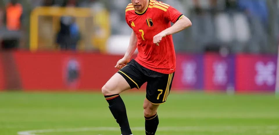 Belgium player dribbling ball on field