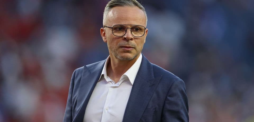 Manager in a suit on the sidelines during match