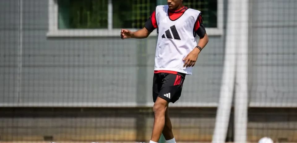 Player training with soccer balls on field