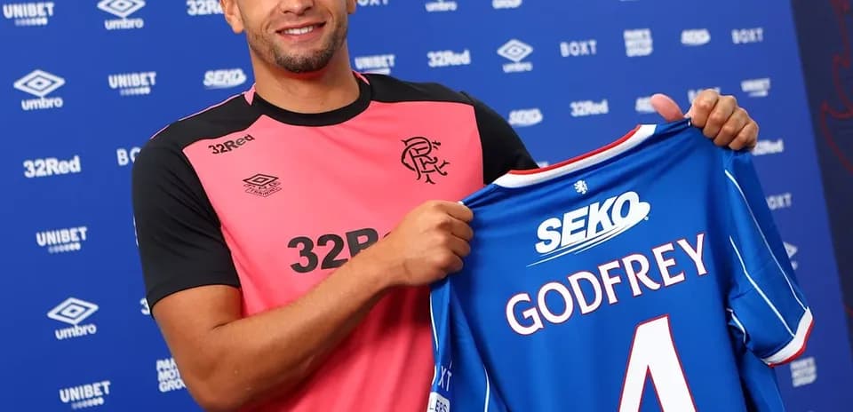 Player holding Rangers jersey with Godfrey printed