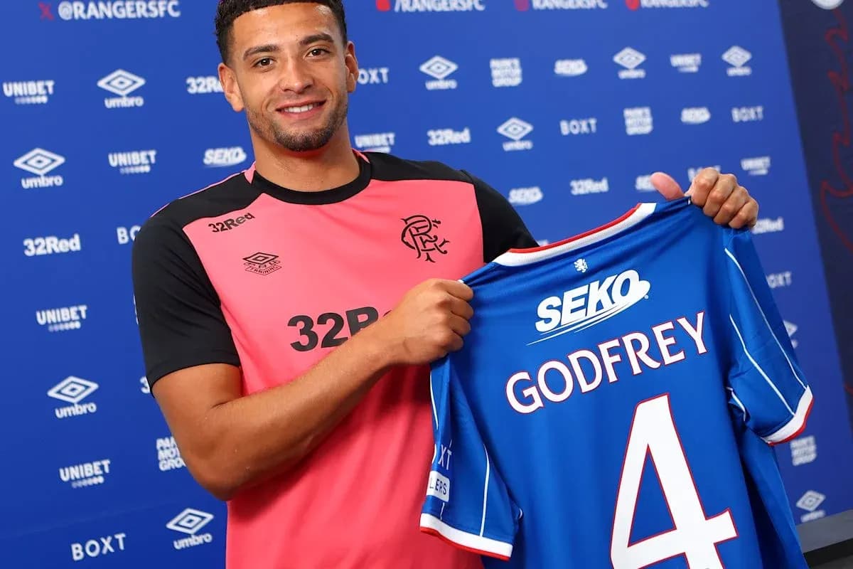 Player holding Rangers jersey with Godfrey printed