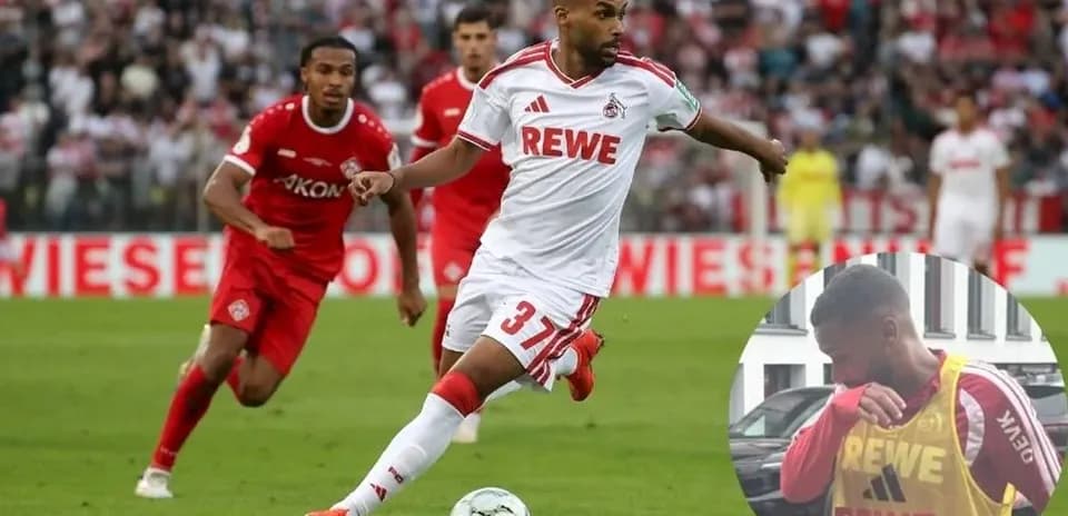 Player in white jersey dribbling during football match