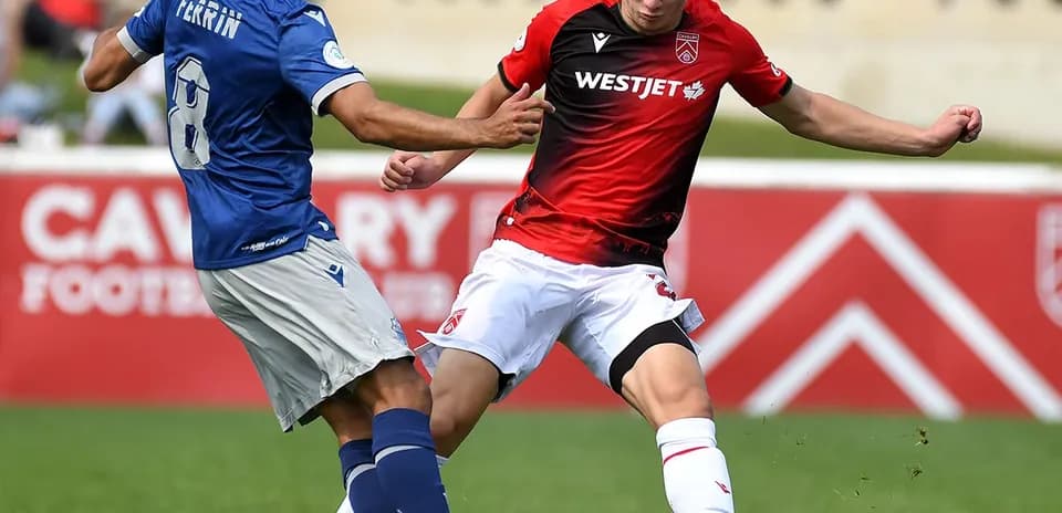 Players competing for the ball in football match