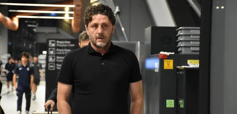 Person walking in airport terminal with luggage