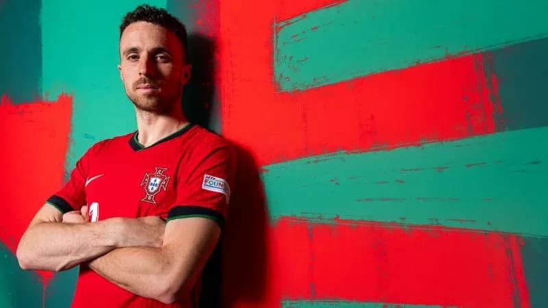 Football player posing in Portugal national team kit