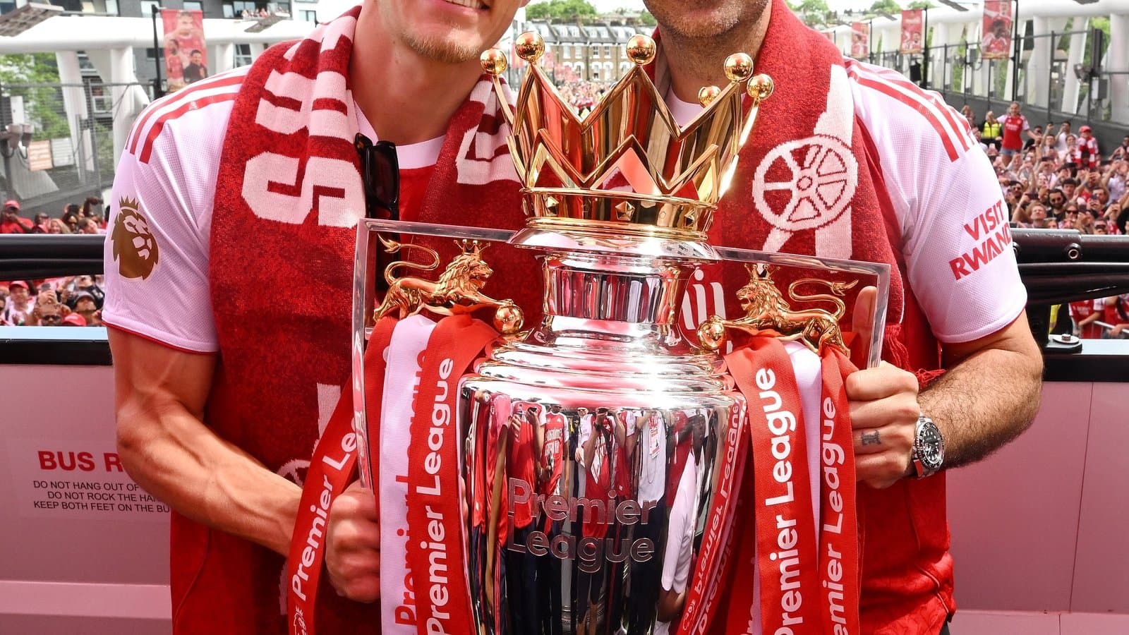 Players celebrating with Premier League trophy on stage