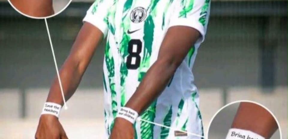 Player wearing jersey with messages on wristbands