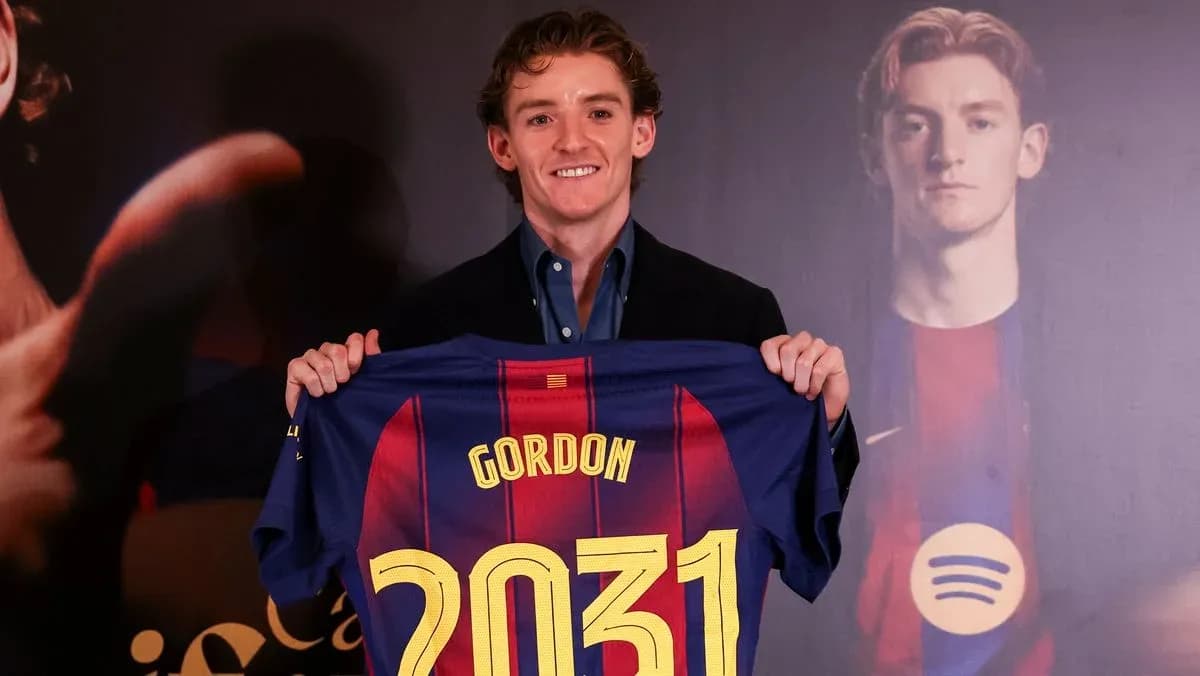 Player holding Barcelona jersey with name and number