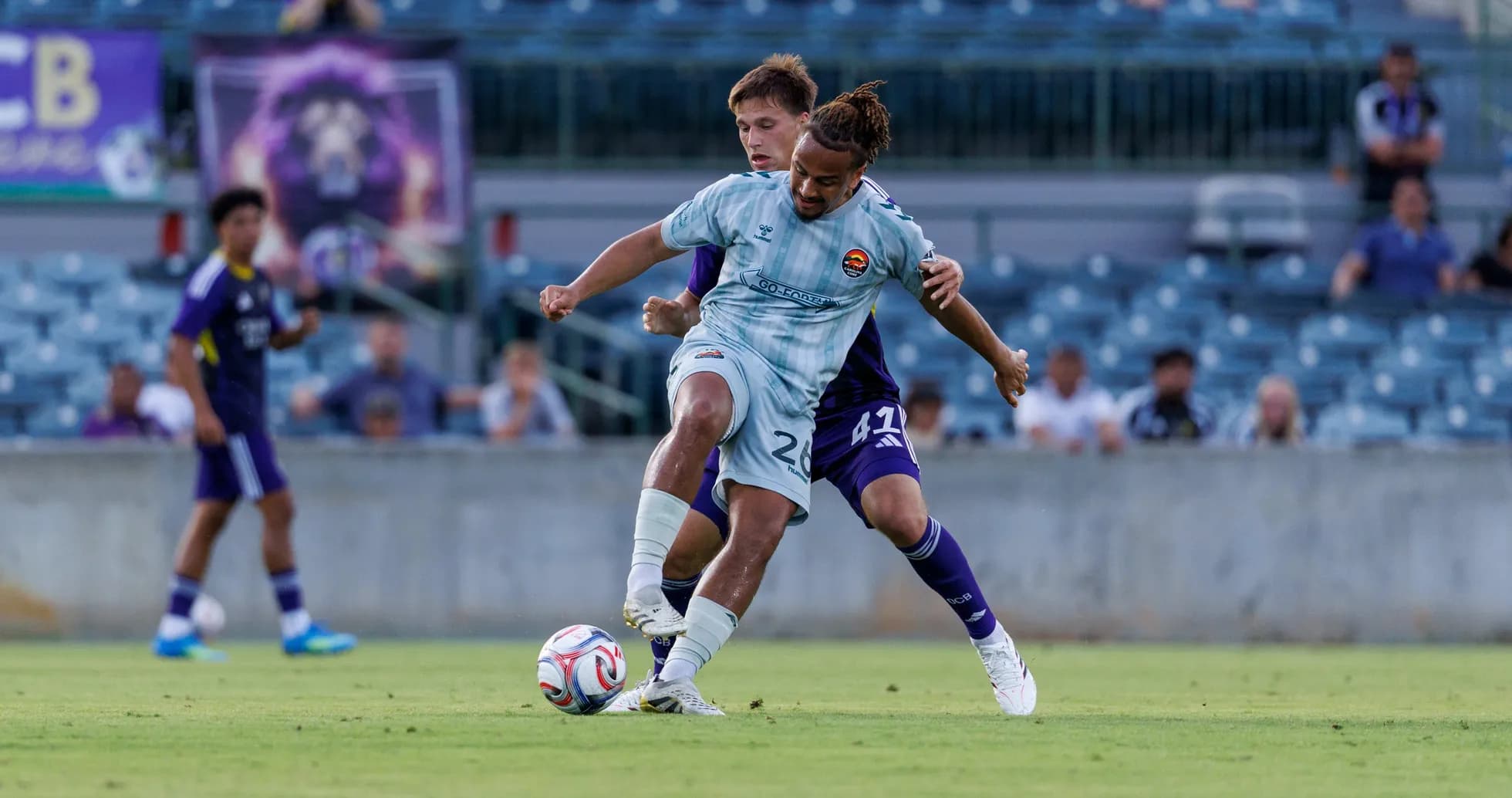 Two players competing for the ball in football match