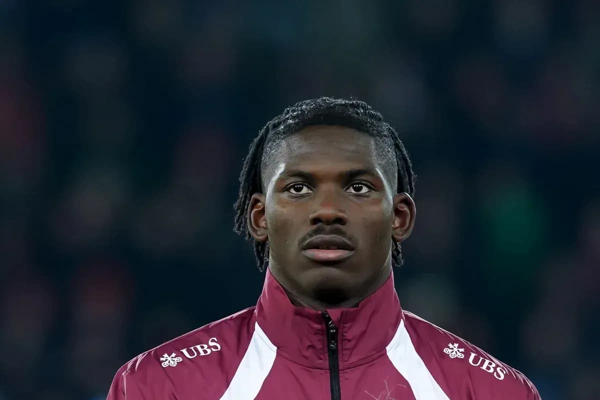Player wearing a maroon jacket during match preparation