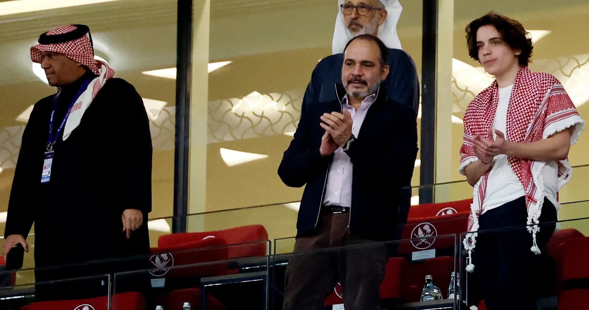 Spectators applauding in the stadium's VIP section