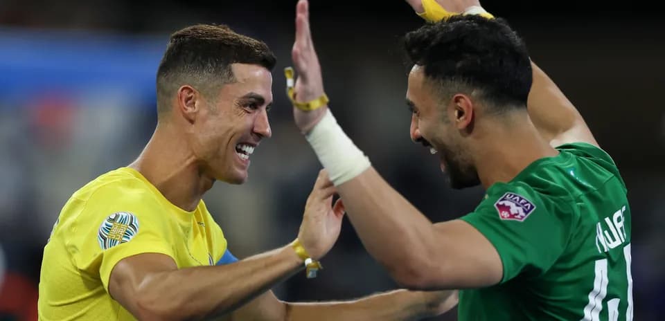 Two players celebrating a goal on the field