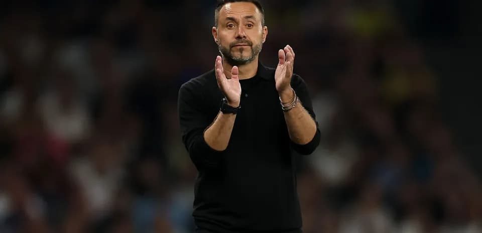 Manager applauding during a football match