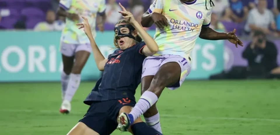 Player tackling during Orlando Pride match