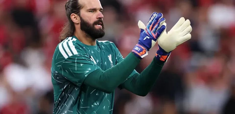 Goalkeeper clapping during a match in green kit