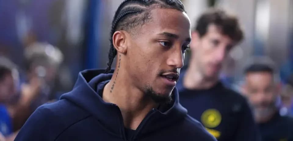 Player with braided hair walking in team hoodie