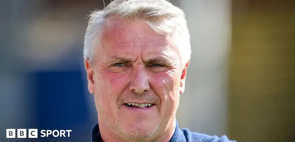 Man with short gray hair smiling outdoors