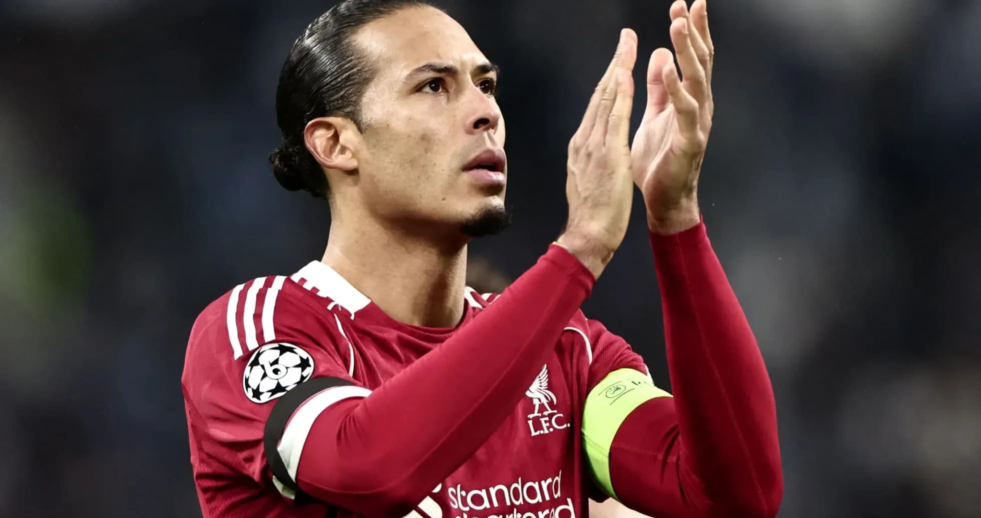 Player applauding fans in Liverpool jersey