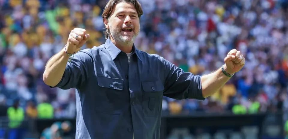 Coach celebrating during a match in stadium